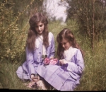 Sisters sitting together in a garden, 1911